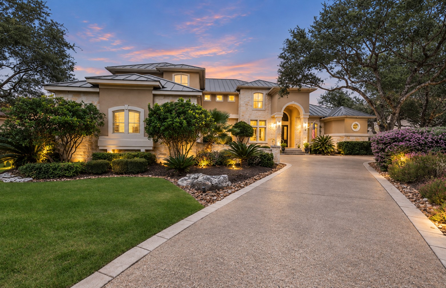 24635 Birdie Rdg, Canyon Springs – stone and stucco home with landscaped drive at twilight