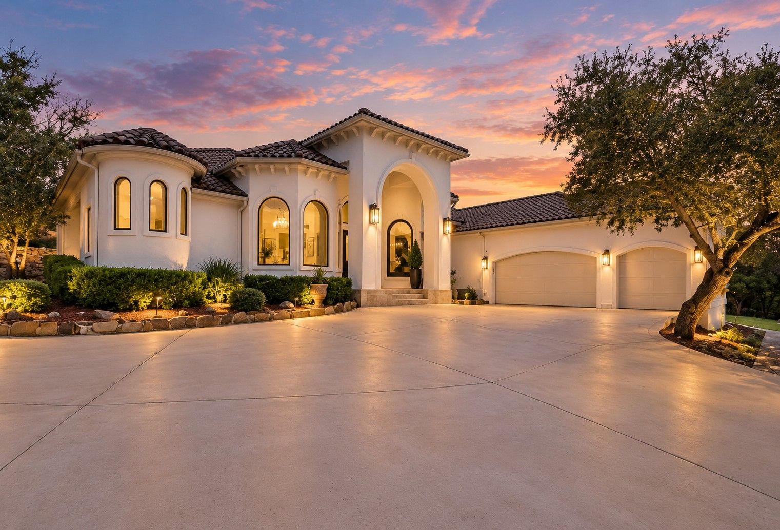 1036 Long Mdw, Spring Branch – Mediterranean-style home and motor court at twilight