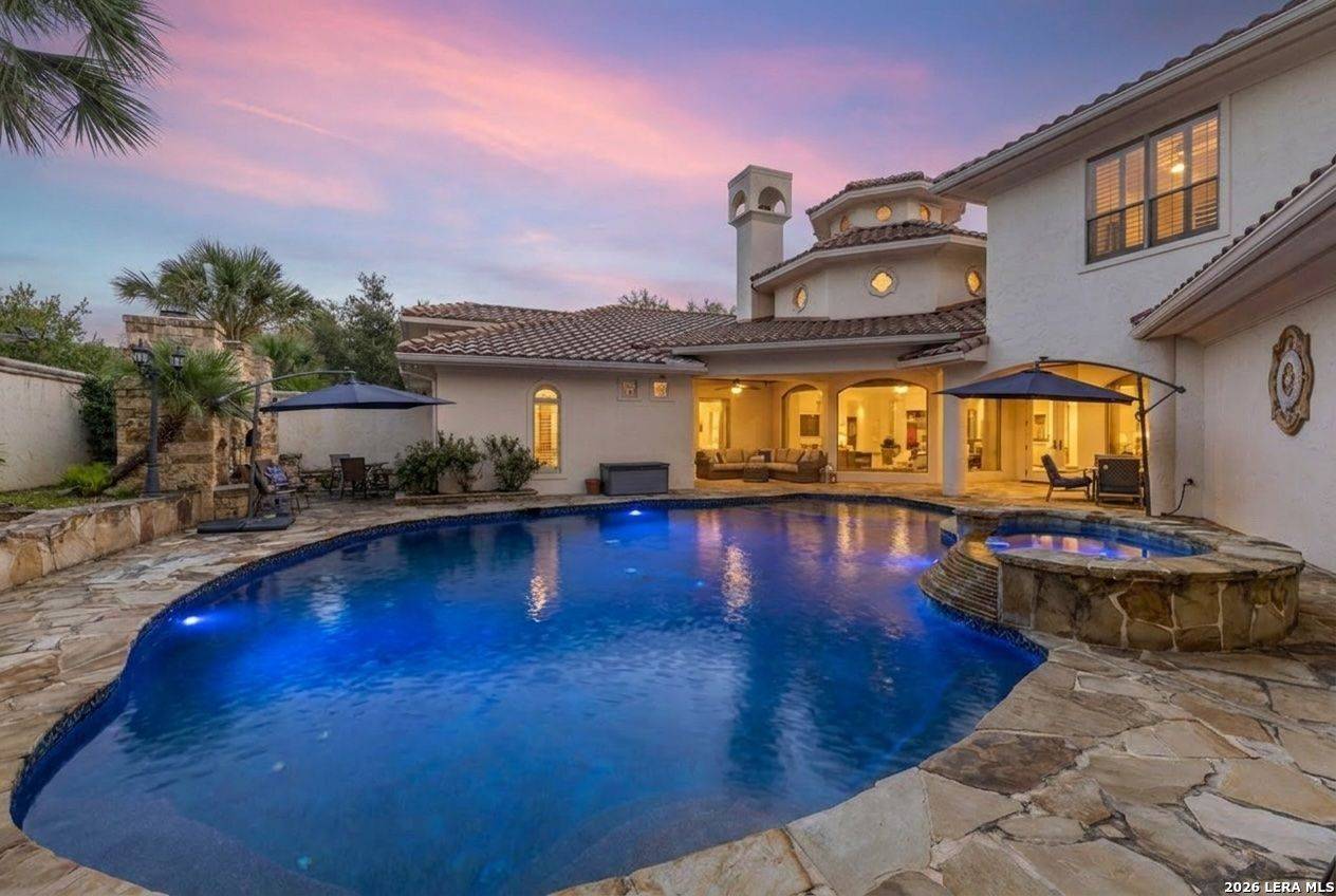2 Belcourt Place at twilight — heated pool, spa and Mediterranean rear elevation in The Dominion, San Antonio