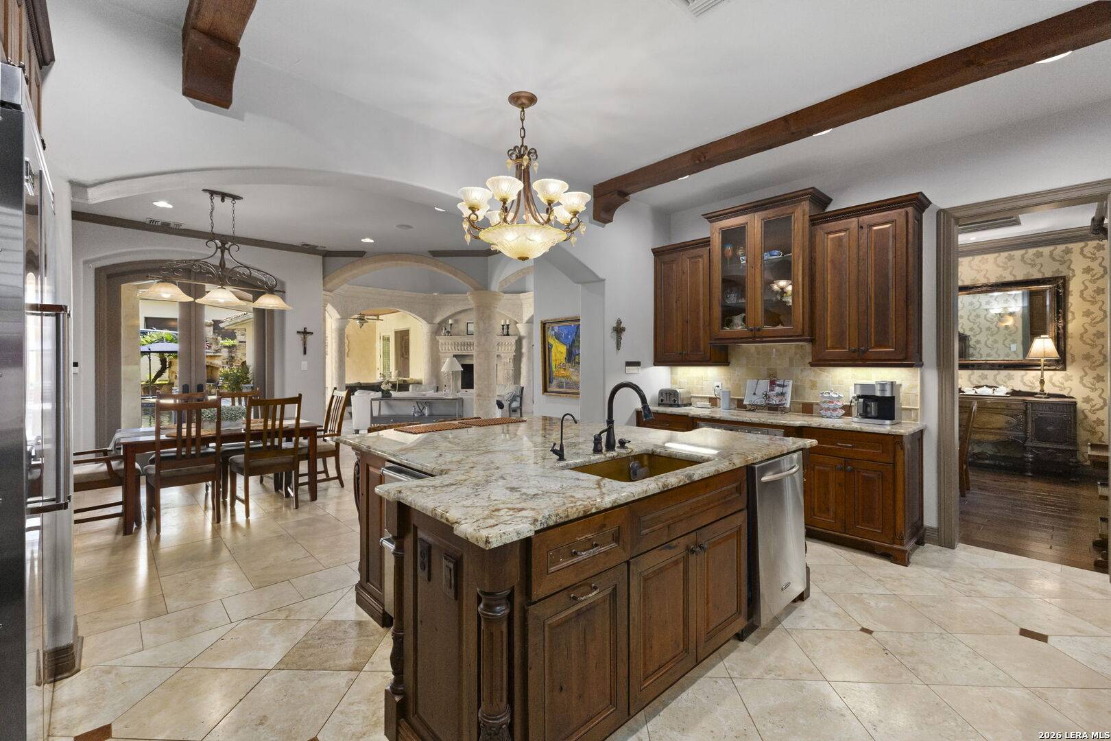 Kitchen and breakfast area of 2 Belcourt Place opening through arches to the family room