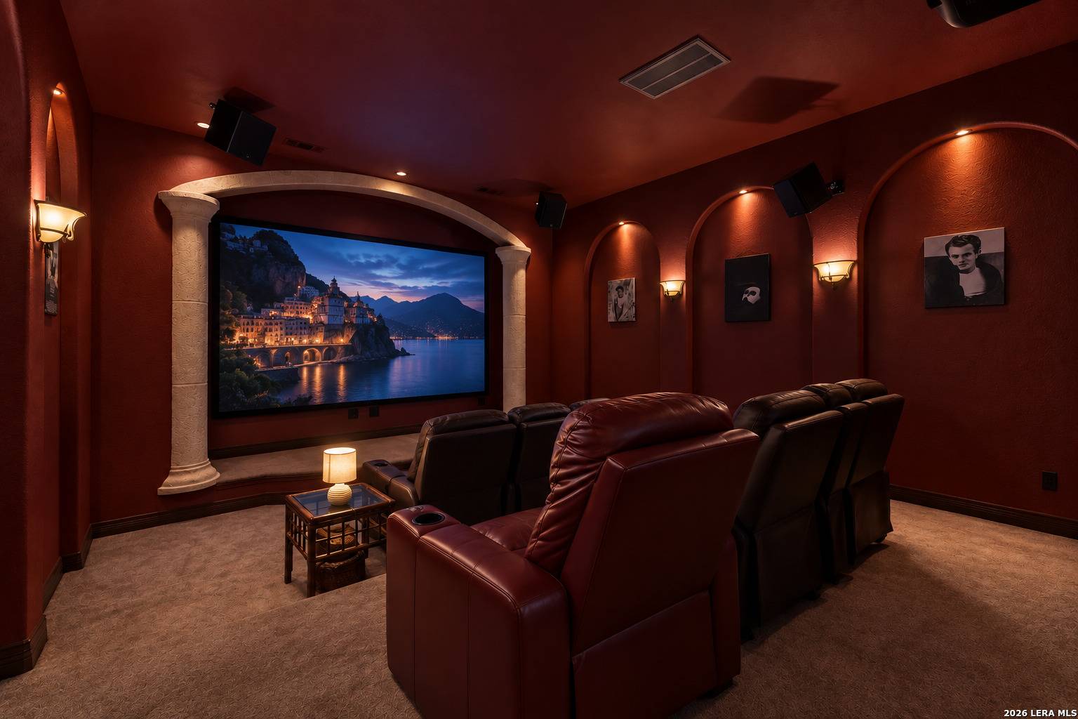 Main-level media room at 2 Belcourt Place with 13-foot Draper projection screen and theater seating