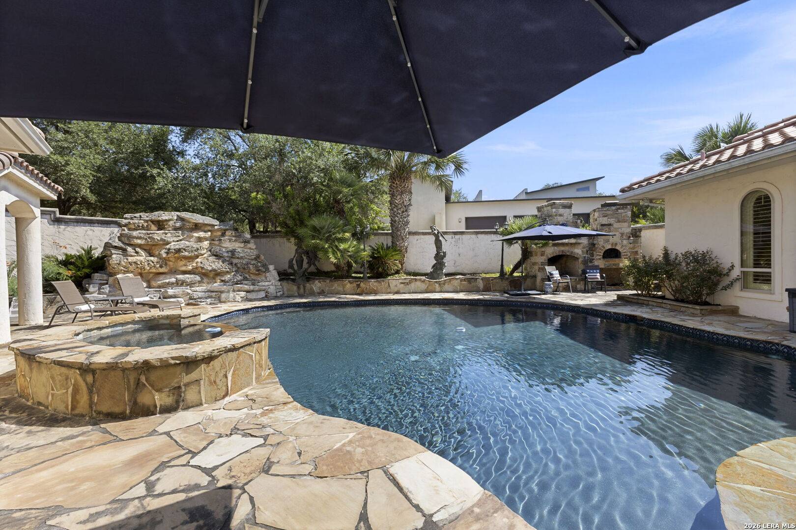 Rock water feature spilling into the heated pool at 2 Belcourt Place