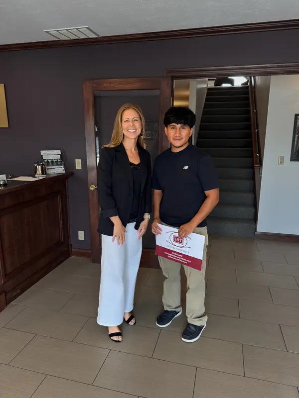 Jen standing with a client at her Seymour, Indiana office.