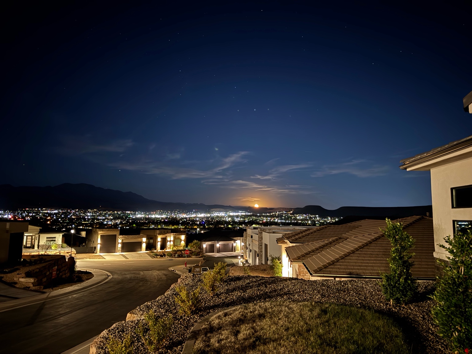 Night view of St. George Utah from Cascata in Divario with city lights and desert homes under a starry sky