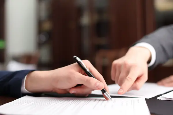 notary-showing-client-where-to-sign-document-in-of-2026-01-11-11-10-04-utc