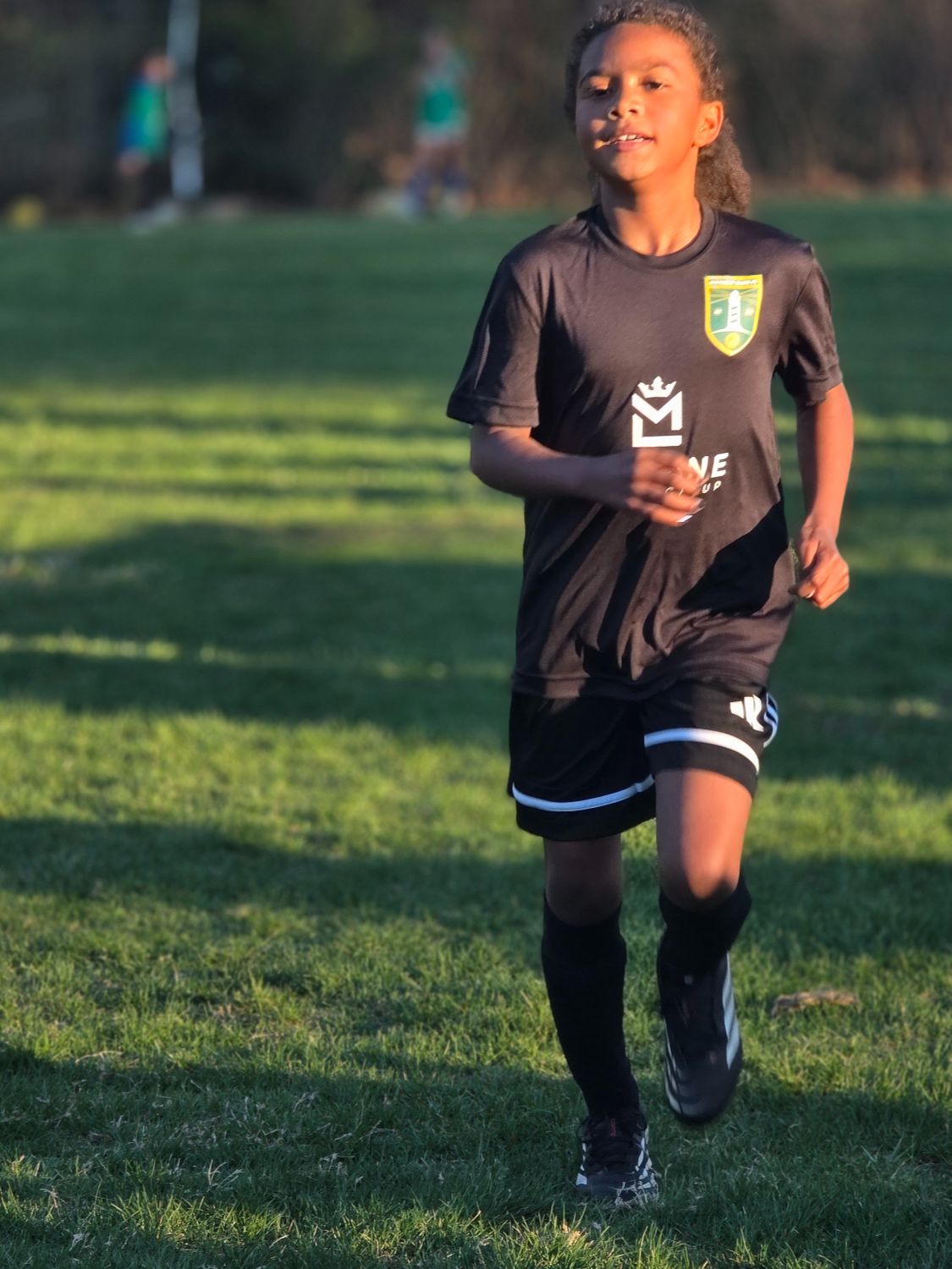 Jasmine racing toward the goal with focus, heart and a love for the game.