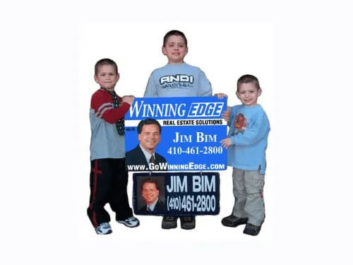 Three children holding Jim Beam and Winning Edge posters