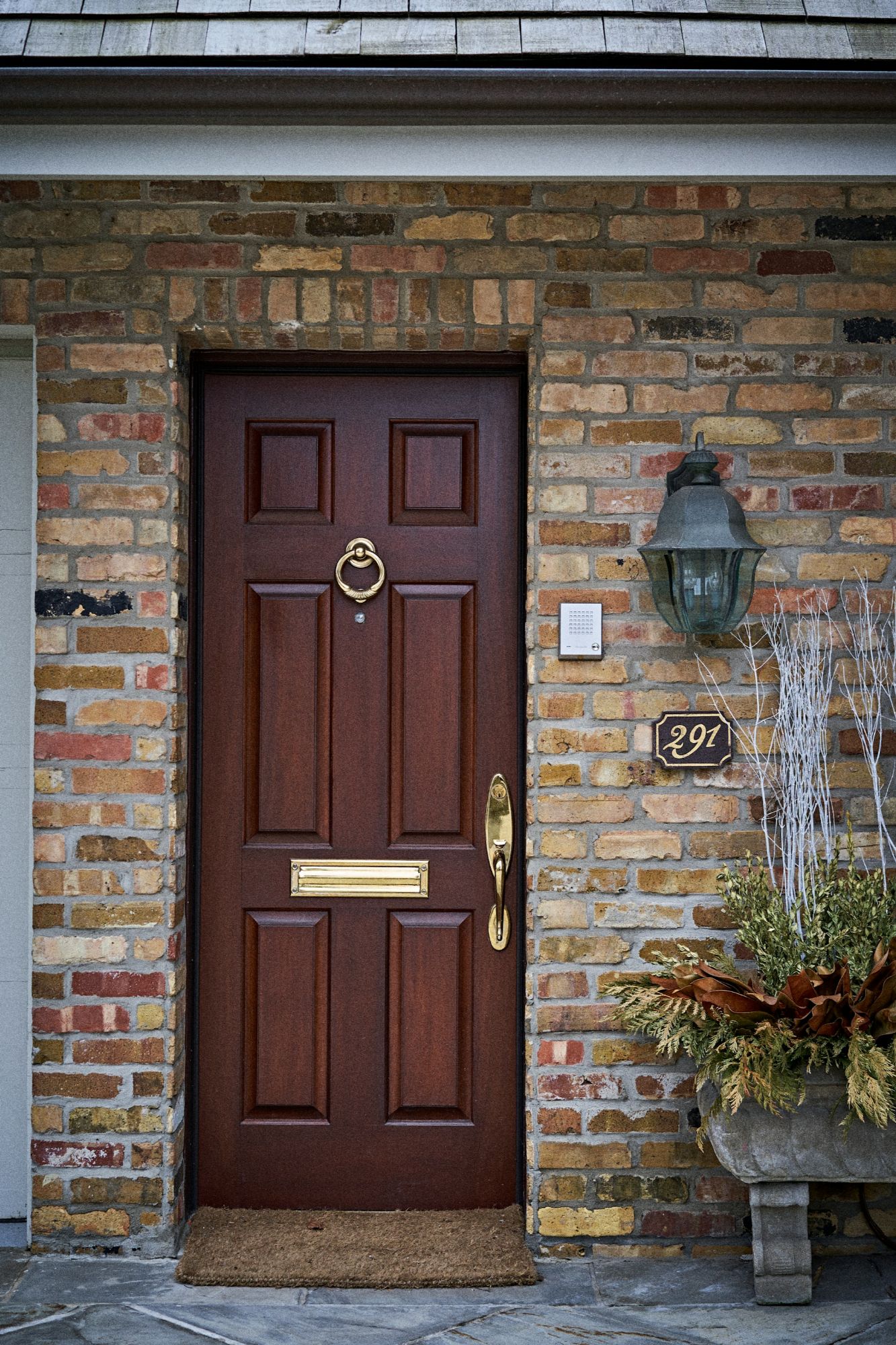 Brown front door with brass hardware