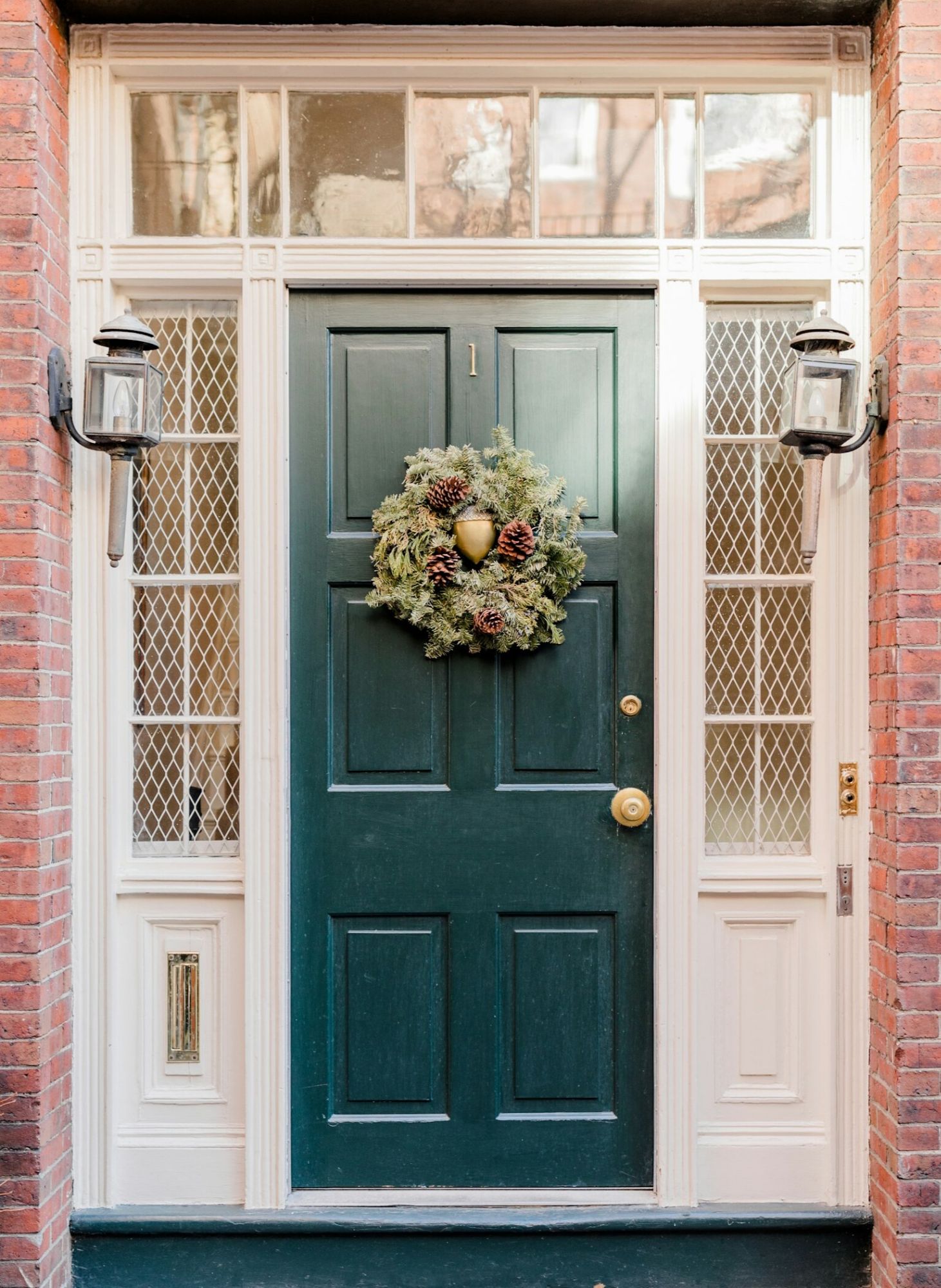 Green front door with wreath