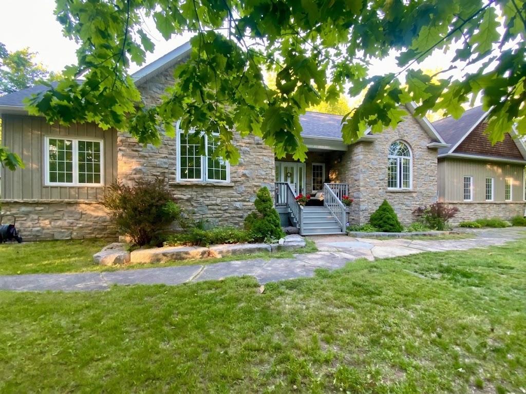Stone bungalow with covered entry in Trent Lakes