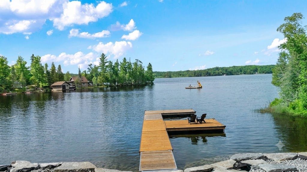 Dock reaching into a calm lake in Trent Lakes