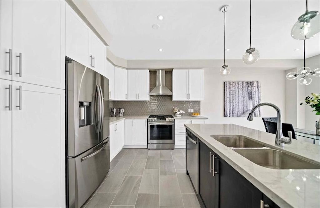 Modern white kitchen with stainless appliances in Clarington