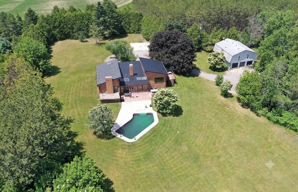 Aerial view of a country property with pool, shop and 27.8 acres