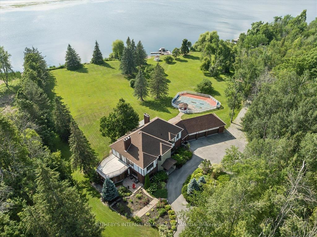 Aerial view of a Selwyn estate with lawns, pool and lake frontage