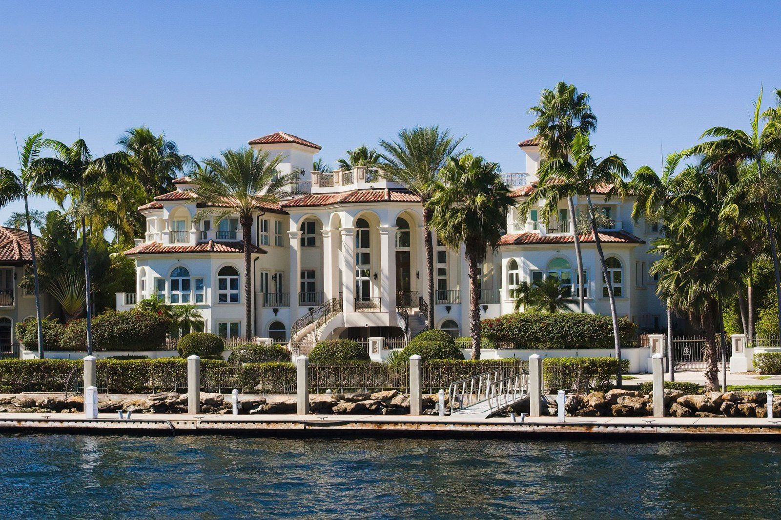 Luxury waterfront estate framed by palm trees