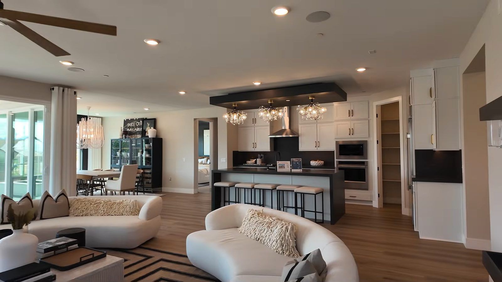 Open great room in the Pulte Parklane model looking toward the kitchen island and dining area