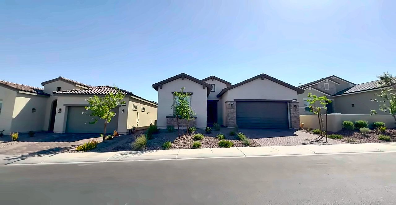 Street of newer single-story homes with desert landscaping in Cadence, Henderson