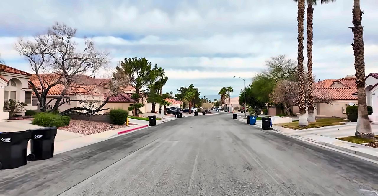 Palm-lined residential street with two-story tile-roof homes in Green Valley, Henderson
