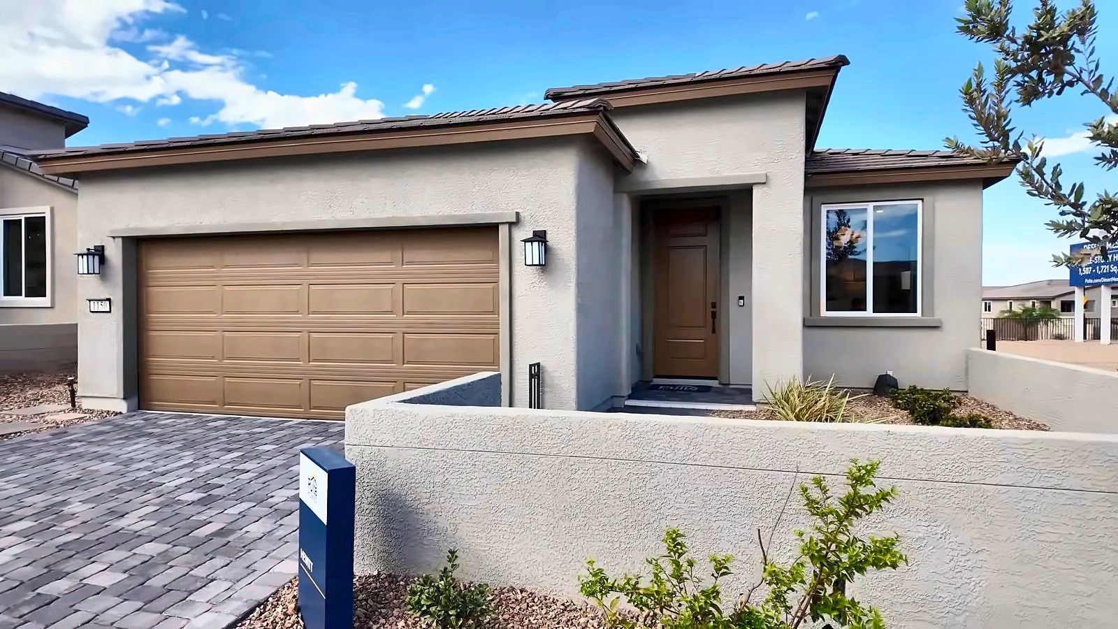 Front exterior of the Pulte Hewitt single-story model home with a two-car garage at Desert Mesa at Aries, Henderson NV