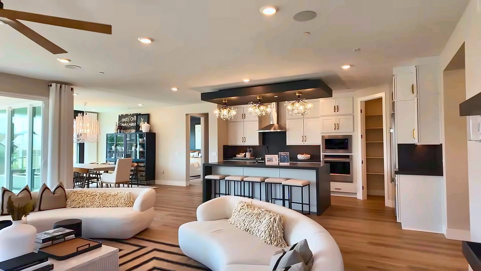 Open great room in the Pulte Parklane model looking toward the kitchen island and dining area