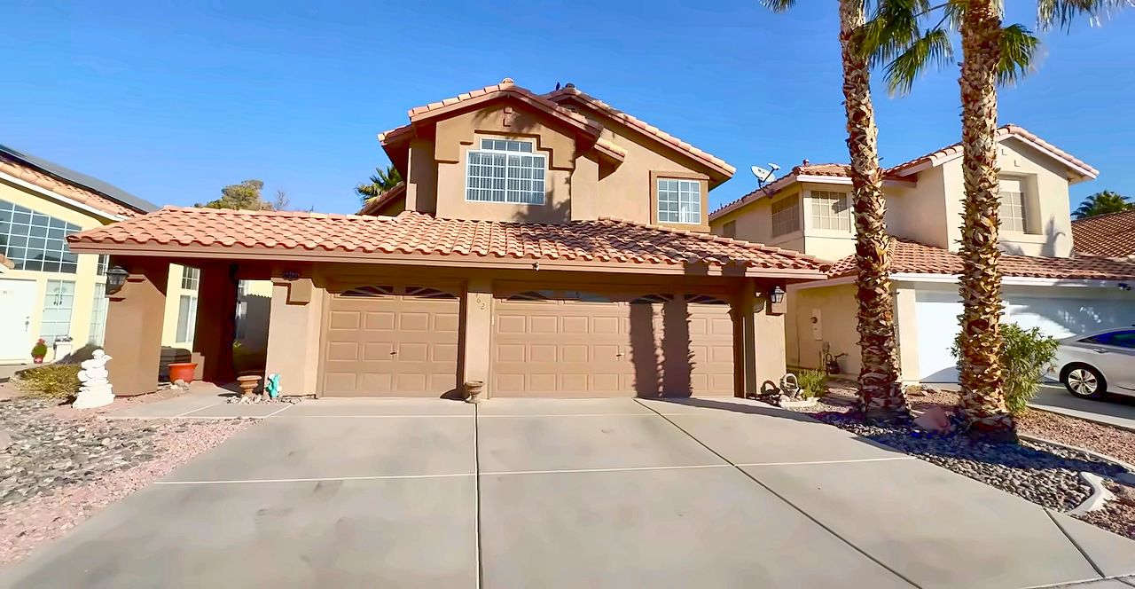 Two-story tile-roof homes with palm trees on a cul-de-sac in Green Valley, Henderson