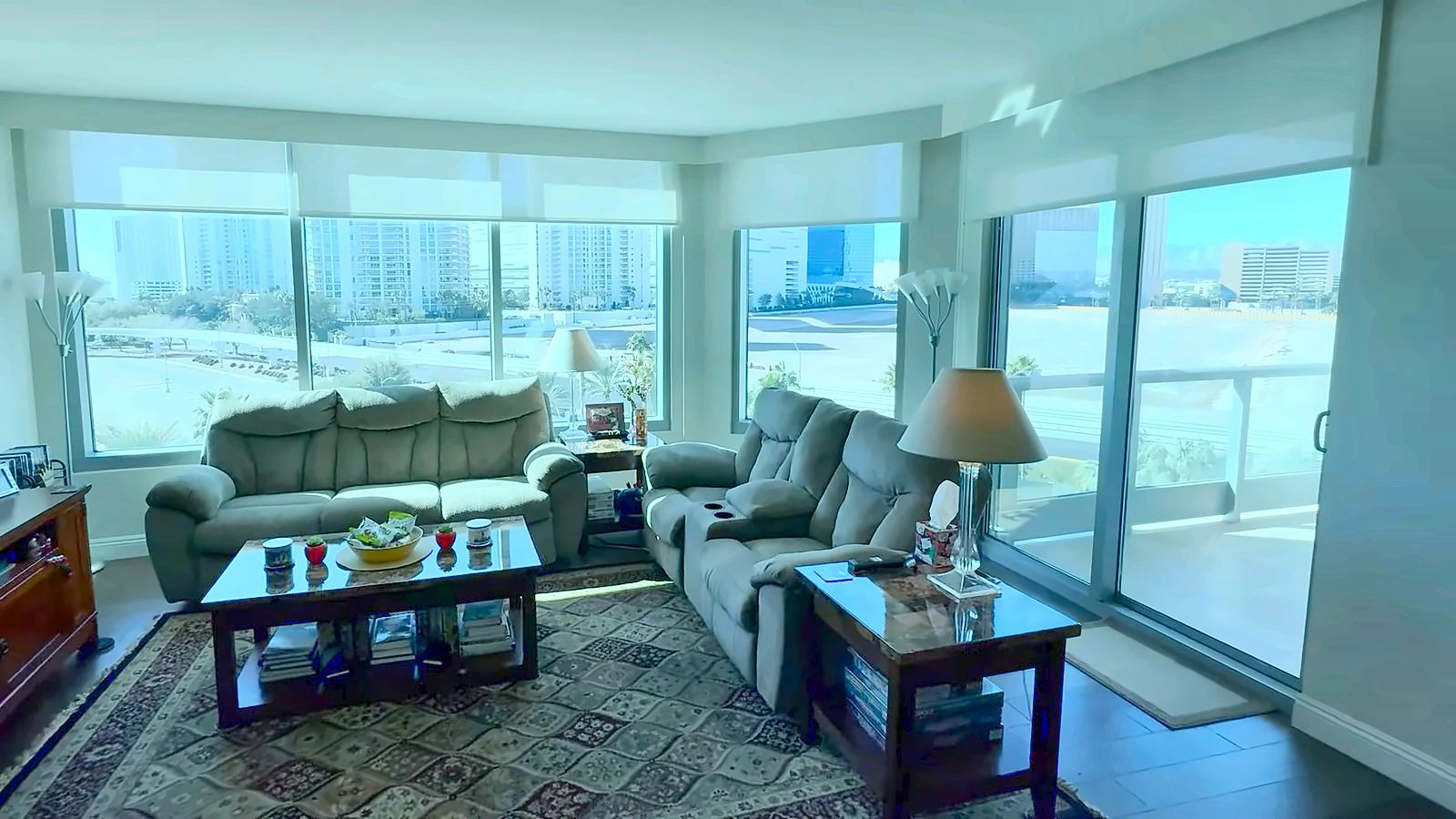 High-rise condo great room with a wall of floor-to-ceiling windows and a glass slider to the terrace in Las Vegas