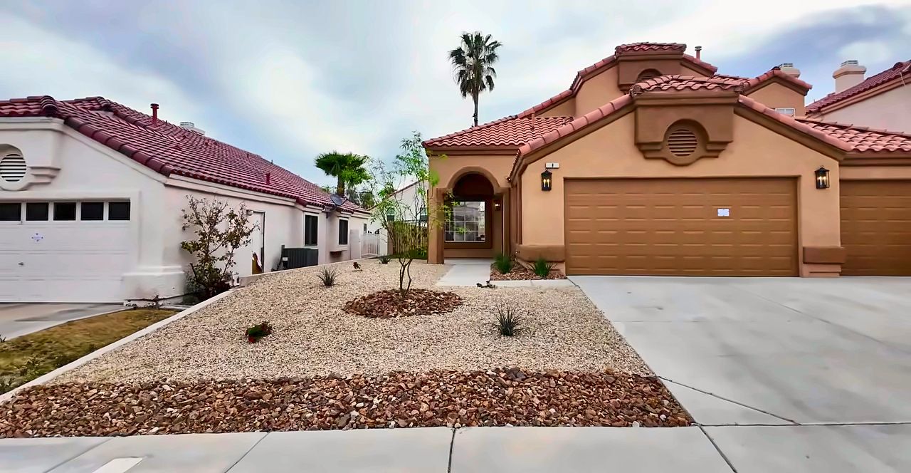 Two-story stucco home with a tile roof and a two-car garage in Green Valley, Henderson