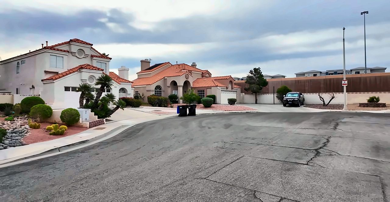 Two-story stucco homes with red tile roofs on a Green Valley street in Henderson, NV 89074
