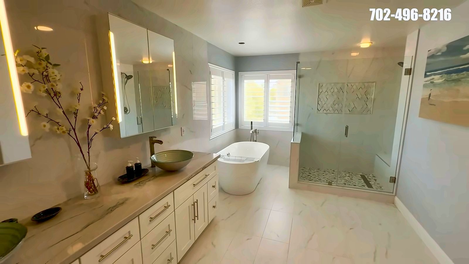 Primary bathroom with a freestanding soaking tub, glass shower and double vanity in a Rhodes Ranch home