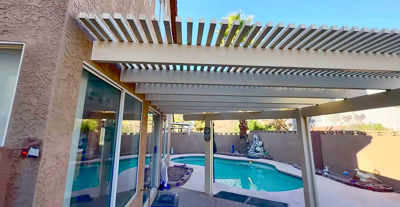 Backyard pool under a lattice patio cover behind a Green Valley home in Henderson