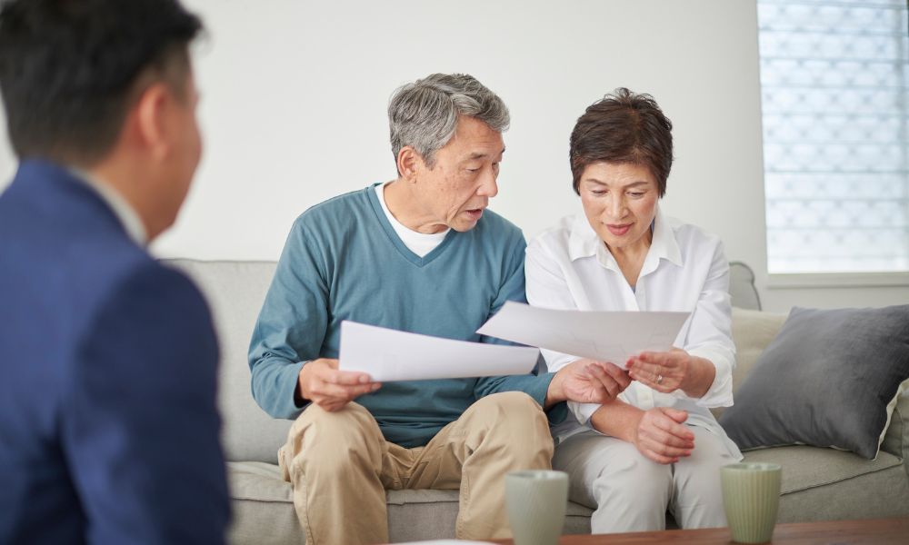 Agent reviewing paperwork with Buyers