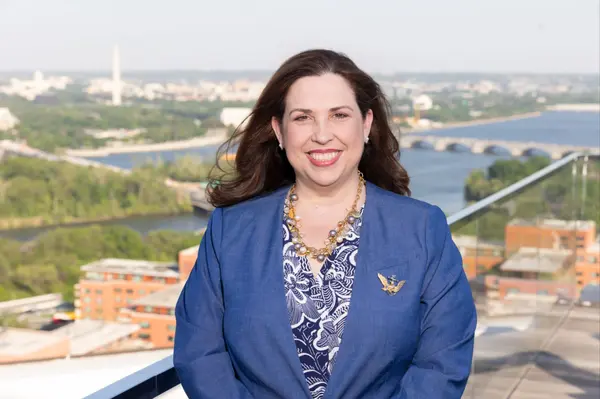 Julie with a gold Navy anchor and DC skyline 