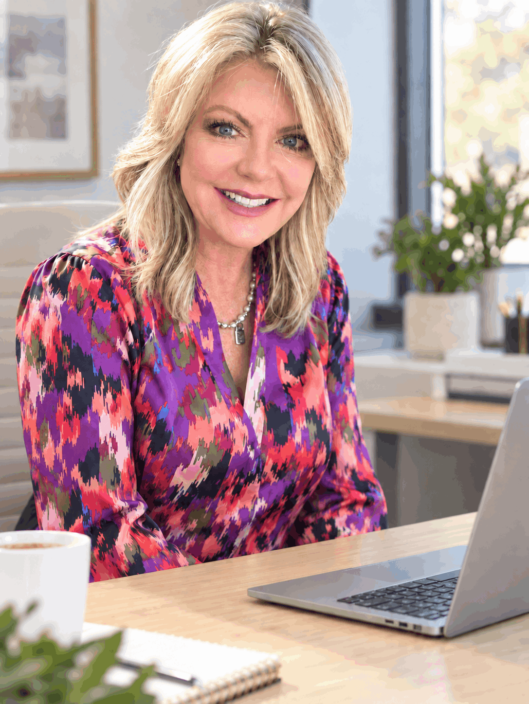 Wendy Bell seated at her desk