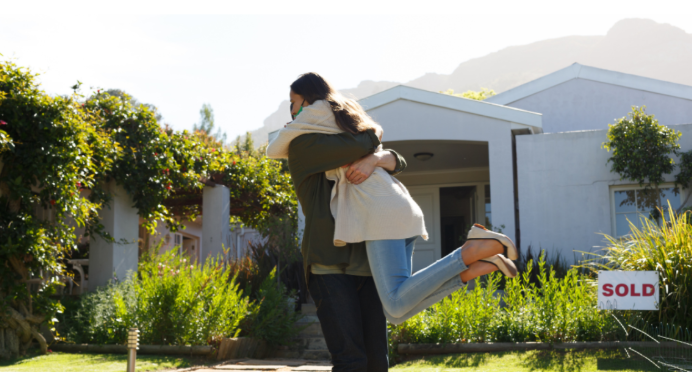 Home buyers celebrating sold house in Harrisonburg real estate market.