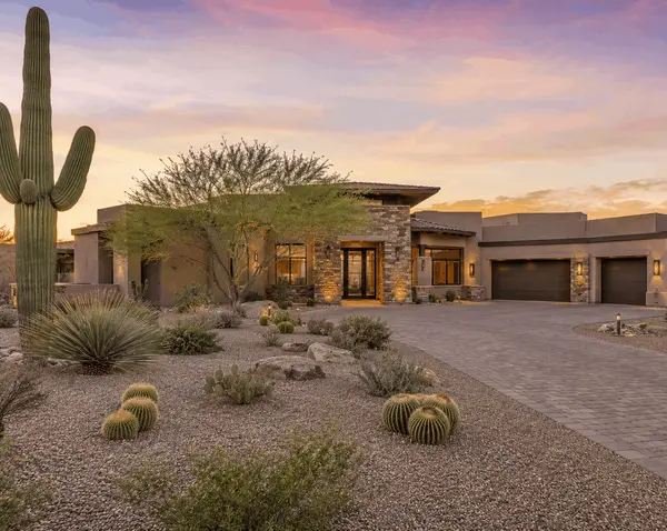 Luxury Scottsdale Arizona home exterior with saguaro cactus desert landscaping and sunset sky