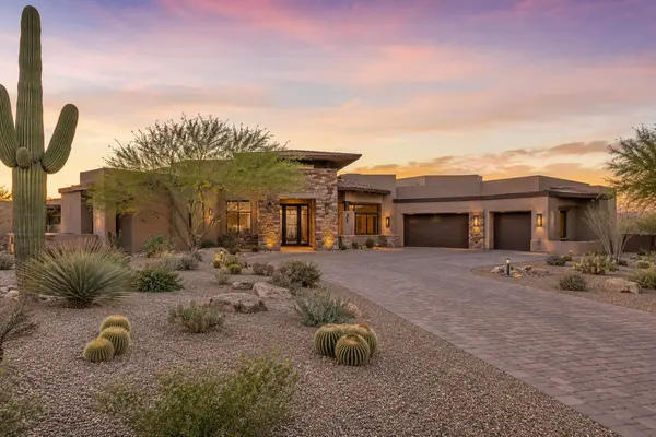 Luxury Scottsdale Arizona home exterior with saguaro cactus desert landscaping and sunset sky