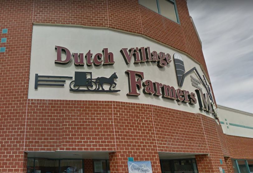 Dutch Village Farmers Market sign on a brick storefront in Prince George's County, Maryland