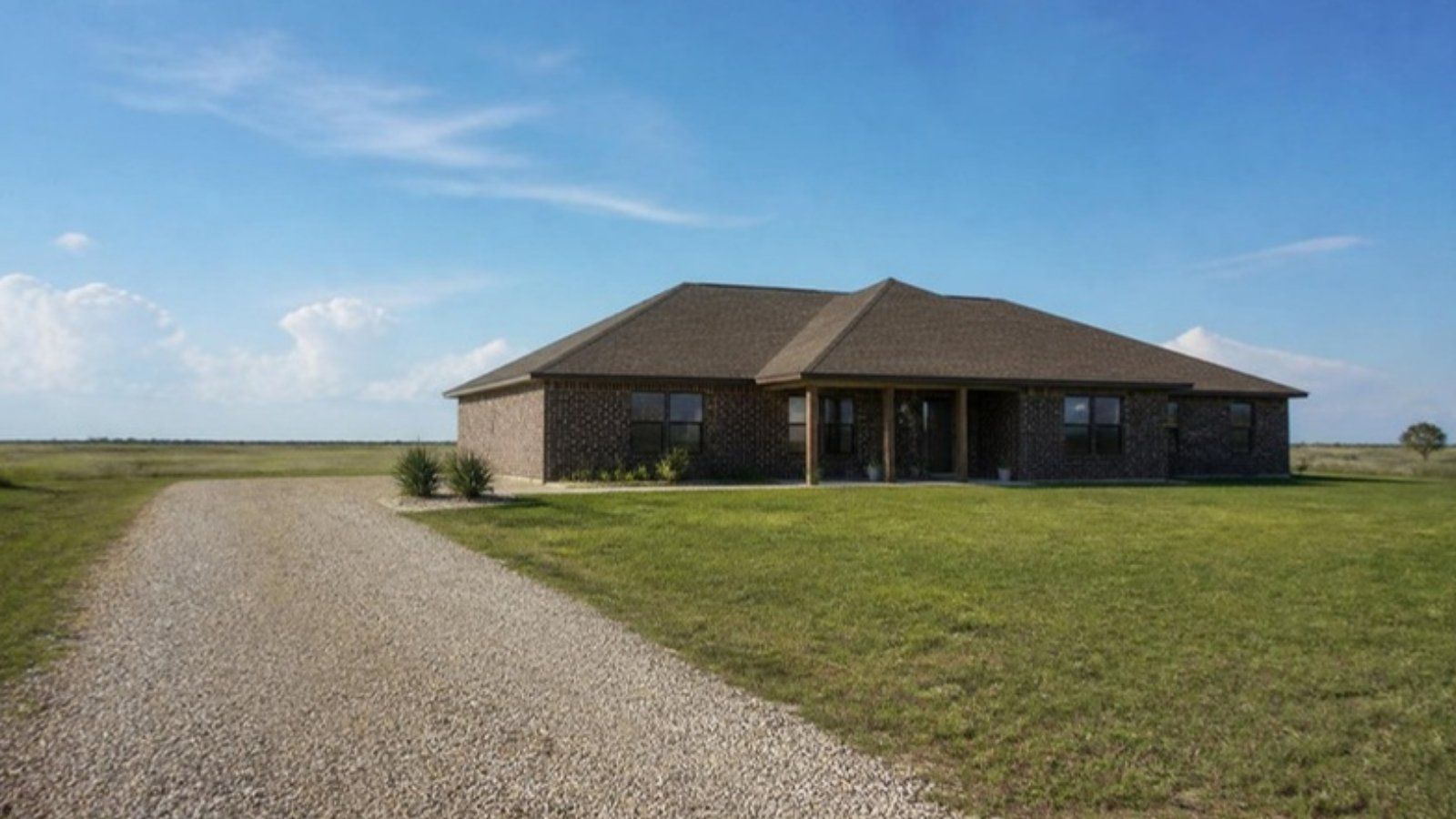 Brick ranch-style home on open prairie land near Brookshire, TX