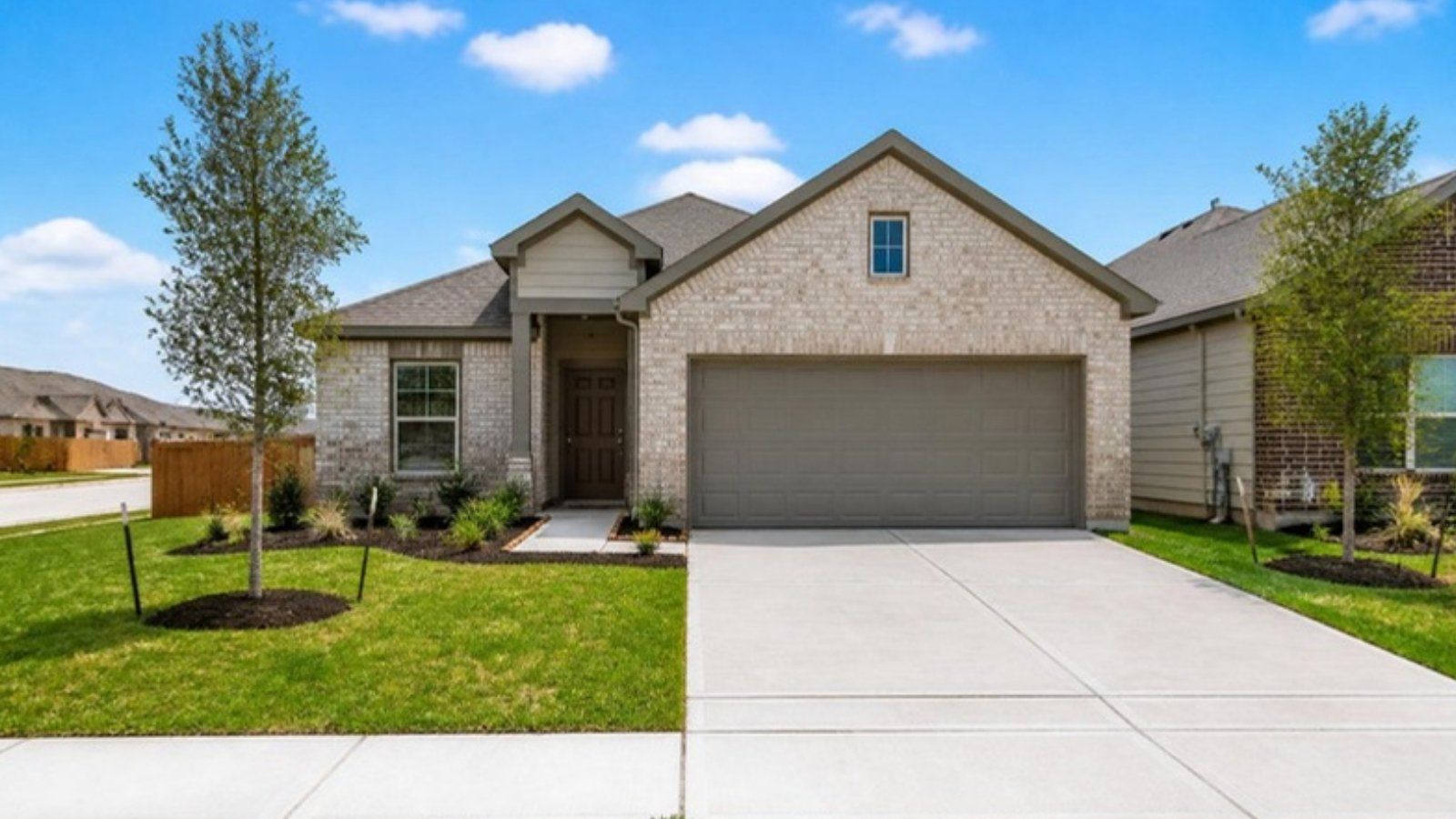 New single-story brick home with a two-car garage in a Rosenberg, TX community