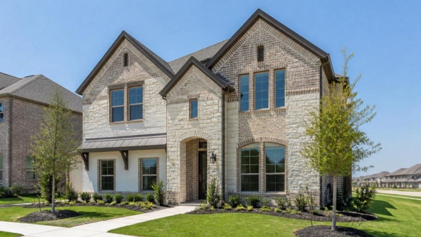 Newly built two-story brick and stone home in a master-planned community in Fulshear, TX