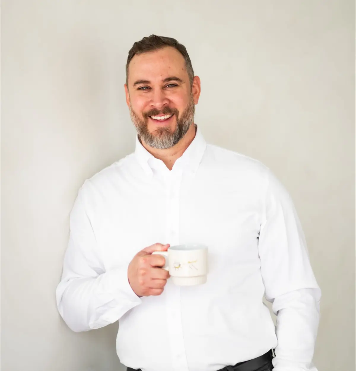 Matt Martin professional headshot, holding a cup of coffee.