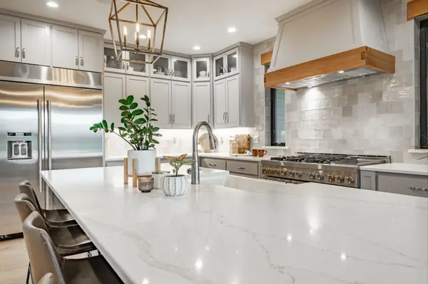 Beautiful kitchen with marble countertops and stainless steel appliances.