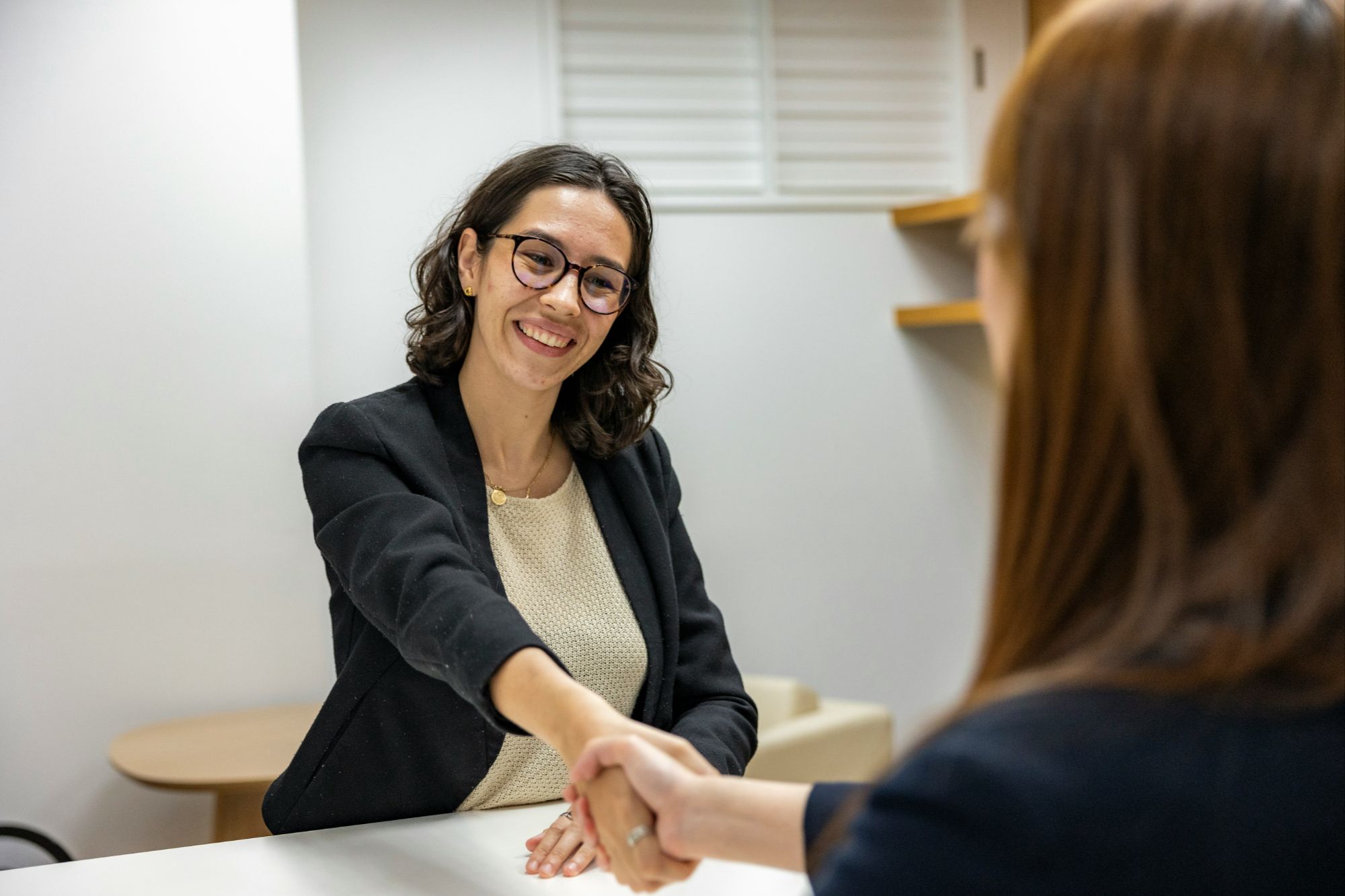 Real estate agent and homeowner shaking hands after accepting an offer