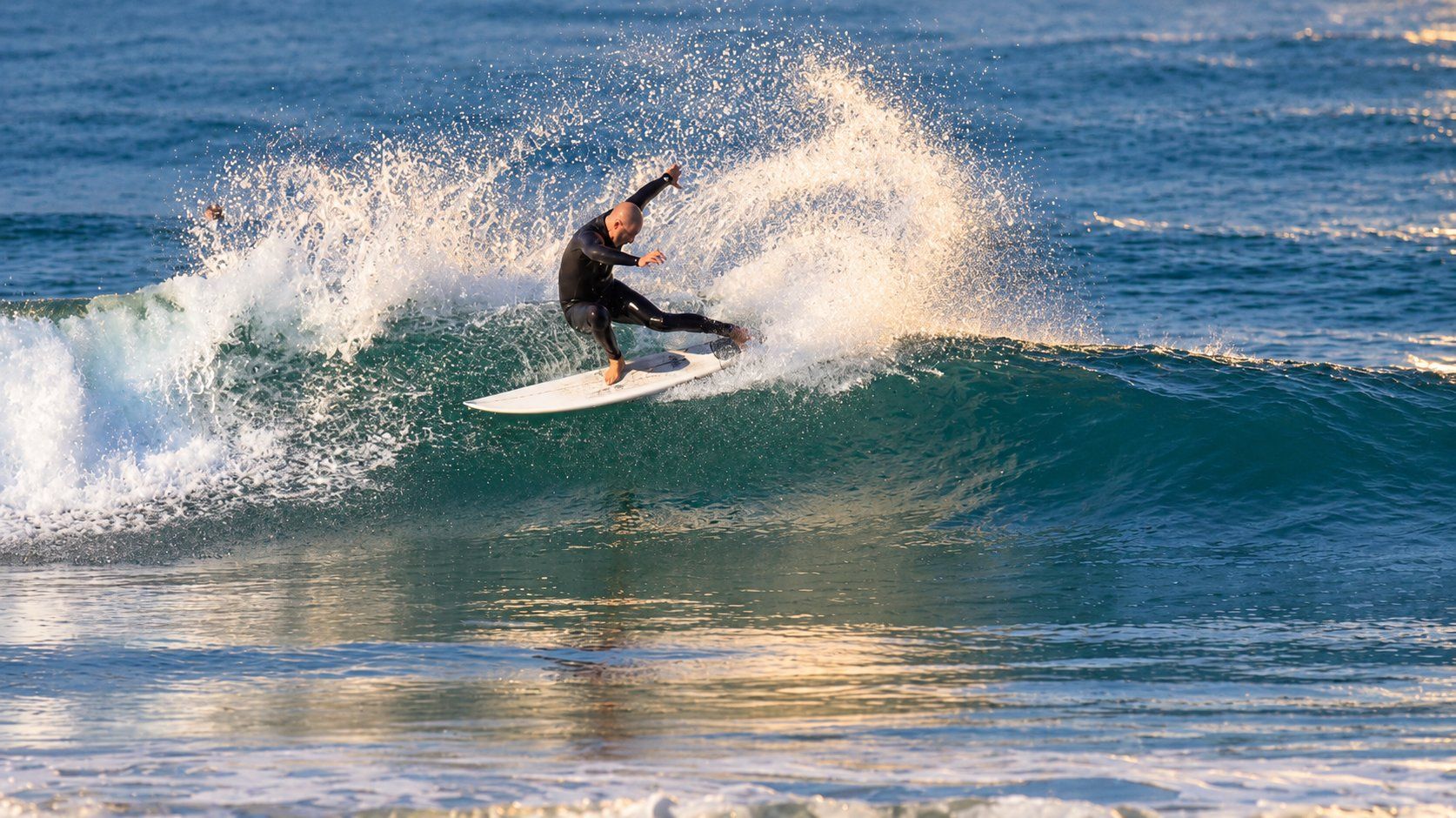 Surfer carving a wave in San Diego