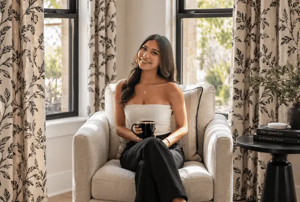 Aiyana Ramirez Sitting On A Chair Holding A Coffee Mug