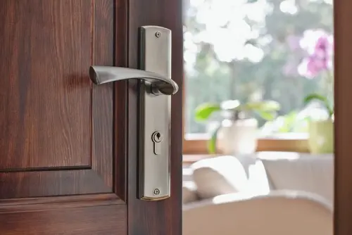 Half opened door into the modern cozy home interior