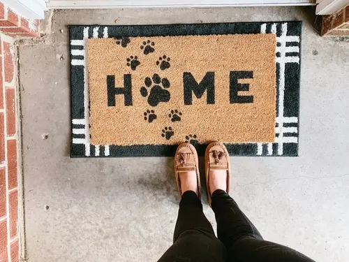 Home welcome mat with paw prints front door