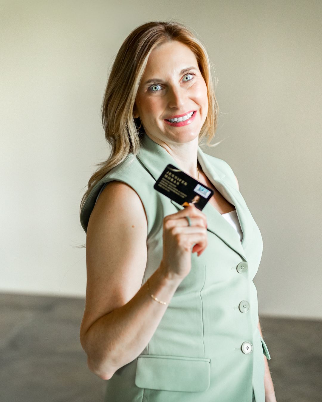 Jennifer Moran holding her business card