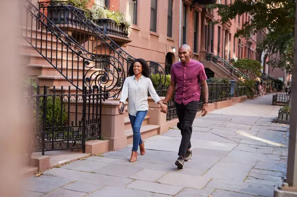 young-couple-walking-along-urban-street-in-new-yor-2026-09-22-18-19-56-utc