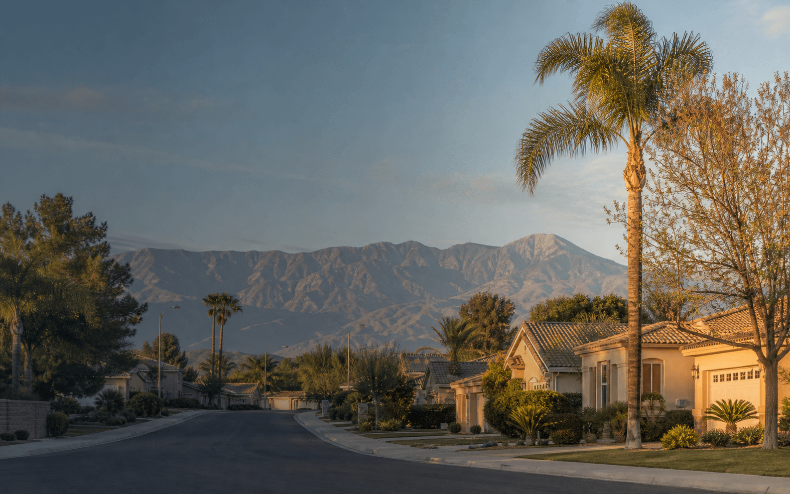 Inland Empire suburban neighborhood street at golden hour with mountains in the background